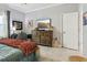 Bedroom featuring a wooden dresser with a TV and a cozy workspace at 1082 Trappers Trail Loop, Davenport, FL 33896