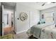Inviting bedroom featuring plush carpet, a floral bedspread, and a decorative mirror at 1082 Trappers Trail Loop, Davenport, FL 33896
