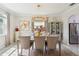 Bright dining room features elegant lighting, décor, stainless appliances and dining table at 1082 Trappers Trail Loop, Davenport, FL 33896