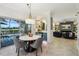 Bright dining area with a marble table, modern lighting, and pool view at 1082 Trappers Trail Loop, Davenport, FL 33896