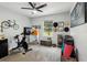 Light-filled exercise room featuring a Peloton bike and views of the golf course at 1082 Trappers Trail Loop, Davenport, FL 33896