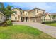 Spacious two-story home with a three-car garage, tile roof and well-maintained landscaping at 1082 Trappers Trail Loop, Davenport, FL 33896