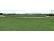 Scenic golf course view with meticulously manicured green, ideal for leisurely afternoons at 1082 Trappers Trail Loop, Davenport, FL 33896