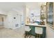 Inviting wet bar with barstool seating, stainless steel appliances and modern design at 1082 Trappers Trail Loop, Davenport, FL 33896