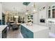 Bright kitchen featuring island with pendant lighting and stainless steel appliances at 1082 Trappers Trail Loop, Davenport, FL 33896