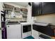 Functional laundry room with modern washer and dryer, storage shelves, and cabinets at 1082 Trappers Trail Loop, Davenport, FL 33896