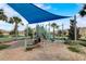 Community playground with shade and play structures, ideal for children at 1082 Trappers Trail Loop, Davenport, FL 33896