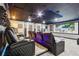 The theater room shows comfortable seating, dark ceilings with accent lighting, and a large projector screen at 1082 Trappers Trail Loop, Davenport, FL 33896