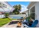 Relaxing backyard patio with hammock, fire pit, and blue lounge chairs, perfect for outdoor enjoyment at 1133 Brandy Lake View Cir, Winter Garden, FL 34787