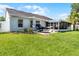 Spacious backyard featuring a well-manicured lawn, inviting patio area with hammock and screened-in porch at 1133 Brandy Lake View Cir, Winter Garden, FL 34787