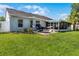 Large backyard showcasing a hammock, lanai, and lush lawn, perfect for outdoor entertaining at 1133 Brandy Lake View Cir, Winter Garden, FL 34787