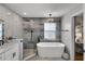 Luxurious bathroom showcasing a freestanding tub, elegant lighting, and separate shower with high-end fixtures at 1133 Brandy Lake View Cir, Winter Garden, FL 34787