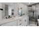 Stylish bathroom featuring double sinks, modern black fixtures, and a luxurious glass-enclosed shower at 1133 Brandy Lake View Cir, Winter Garden, FL 34787