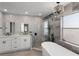 Luxurious bathroom with elegant herringbone tile, modern fixtures, a standalone tub, and stylish chandelier at 1133 Brandy Lake View Cir, Winter Garden, FL 34787