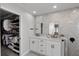 Bright bathroom featuring a double sink vanity, sleek black fixtures, and a spacious walk-in closet at 1133 Brandy Lake View Cir, Winter Garden, FL 34787