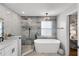 Stylish bathroom with free standing tub, elegant lighting, walk-in shower, and modern double vanity at 1133 Brandy Lake View Cir, Winter Garden, FL 34787