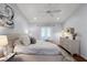 Bright bedroom featuring a large bed, light wood floors, and a view to a private balcony at 1133 Brandy Lake View Cir, Winter Garden, FL 34787