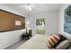 Bright bedroom with natural light from a window and featuring cork board and artwork at 1133 Brandy Lake View Cir, Winter Garden, FL 34787