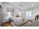 Bright bedroom featuring a large bed, light wood floors, and a view to a private balcony at 1133 Brandy Lake View Cir, Winter Garden, FL 34787