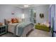 Charming bedroom featuring a plush bed, colorful pillows, and accents of greenery, creating a cozy and inviting space at 1133 Brandy Lake View Cir, Winter Garden, FL 34787