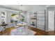 Charming dining room with contemporary table, chairs, chandelier, and shelving at 1133 Brandy Lake View Cir, Winter Garden, FL 34787