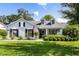 Charming single-story home featuring dormer windows, black shutters, and lush landscaping at 1133 Brandy Lake View Cir, Winter Garden, FL 34787
