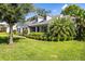 Beautiful home exterior with lush green lawn, mature trees, and manicured shrubbery at 1133 Brandy Lake View Cir, Winter Garden, FL 34787