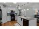 Well-lit kitchen featuring white cabinets, stainless steel appliances, granite countertops, and a center island with a sink at 1133 Brandy Lake View Cir, Winter Garden, FL 34787