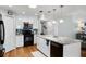 Bright kitchen boasts a large island, granite counters, stainless steel appliances, and ample white cabinetry at 1133 Brandy Lake View Cir, Winter Garden, FL 34787