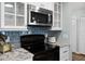 Close-up of modern kitchen featuring stainless steel appliances and blue tiled backsplash at 1133 Brandy Lake View Cir, Winter Garden, FL 34787