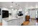 Open kitchen featuring a large island with sink, granite countertops, stainless steel appliances, and hardwood floors at 1133 Brandy Lake View Cir, Winter Garden, FL 34787