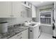 Well-organized laundry room featuring modern washer/dryer, counter space and cabinets at 1133 Brandy Lake View Cir, Winter Garden, FL 34787