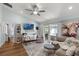 Bright living room with a ceiling fan, plush seating, and sliding glass doors to the lanai at 1133 Brandy Lake View Cir, Winter Garden, FL 34787