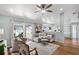 Inviting living area with stylish furniture, a ceiling fan, and sliding glass doors at 1133 Brandy Lake View Cir, Winter Garden, FL 34787