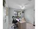 Bright office with large window, ceiling fan, neutral walls and carpet, with light wood desk and chair at 1133 Brandy Lake View Cir, Winter Garden, FL 34787