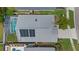 Aerial shot of the home featuring a pool, screened-in patio, and solar panels on the roof at 12832 Downstream Cir, Orlando, FL 32828