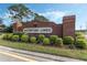 Welcome to Waterford Lakes, a lovely community entrance framed by lush greenery and brick architecture at 12832 Downstream Cir, Orlando, FL 32828