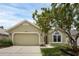 Charming single-Gathering home boasts a well-maintained lawn, a two-car garage, and fresh exterior paint at 12832 Downstream Cir, Orlando, FL 32828