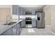 Modern kitchen with stainless steel appliances, granite countertops, and ample storage at 12832 Downstream Cir, Orlando, FL 32828