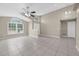 Bright living room with vaulted ceilings, ceiling fan, neutral paint, and tile flooring throughout at 12832 Downstream Cir, Orlando, FL 32828