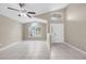 Bright living room with vaulted ceilings, ceiling fan, neutral paint, and tile flooring throughout at 12832 Downstream Cir, Orlando, FL 32828