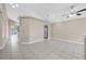 Bright living room with vaulted ceilings, ceiling fan, neutral paint, and tile flooring throughout at 12832 Downstream Cir, Orlando, FL 32828