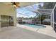 Enclosed pool area with clear blue water, ample patio space, and screened enclosure at 12832 Downstream Cir, Orlando, FL 32828