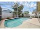 Backyard pool features a screened enclosure, surrounding landscaping, and clear blue water at 12832 Downstream Cir, Orlando, FL 32828