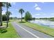 Scenic walking path alongside a tranquil lake, perfect for outdoor enjoyment in this community at 12832 Downstream Cir, Orlando, FL 32828