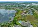 Aerial view of a luxury estate community with private boat docks, lush green lawns and shimmering lake at 13120 Zori Ln, Windermere, FL 34786
