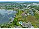 Aerial view of a luxury estate community with private boat docks, lush green lawns and shimmering lake at 13120 Zori Ln, Windermere, FL 34786