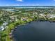 Wide aerial view captures a lakefront neighborhood with multiple docks and peaceful water scenery at 13120 Zori Ln, Windermere, FL 34786