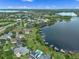 Expansive aerial shot of a lakefront community with houses featuring docks and tranquil lake views at 13120 Zori Ln, Windermere, FL 34786