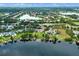 An aerial view showcases a lakeside community with private boat docks and lush green landscaping at 13120 Zori Ln, Windermere, FL 34786